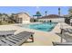 Community pool with lounge chairs and a building that is surrounded by a metal fence at 10286 Cypress Knee Cir, Orlando, FL 32825