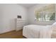 Bright bedroom featuring neutral decor, a dresser and a view of the outdoors at 11619 Chateaubriand Ave, Orlando, FL 32836