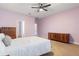 Bedroom with purple walls, neutral carpet and access to en-suite bathroom at 11619 Chateaubriand Ave, Orlando, FL 32836