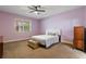 Light purple bedroom with a ceiling fan and light filtering window blinds at 11619 Chateaubriand Ave, Orlando, FL 32836