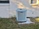 Air Conditioning unit, sitting on the edge of the home's yard on a concrete slab at 12314 Virginia Dr, Leesburg, FL 34788