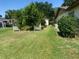 Expansive backyard with lush green lawn and well-maintained landscaping on a sunny day at 12314 Virginia Dr, Leesburg, FL 34788