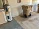 Basement with a water heater, concrete floor and a trash can at 12314 Virginia Dr, Leesburg, FL 34788