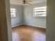 Bedroom with two windows and a ceiling fan at 12314 Virginia Dr, Leesburg, FL 34788