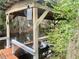 Boat house with a lifting mechanism over the water, surrounded by lush foliage at 12314 Virginia Dr, Leesburg, FL 34788