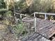 Weathered dock with broken railings, overgrown foliage, and water view, needing repair at 12314 Virginia Dr, Leesburg, FL 34788