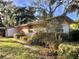 Quaint home exterior featuring lush landscaping and a partially obscured view, offering privacy at 12314 Virginia Dr, Leesburg, FL 34788