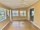 Bright sunroom with tan walls, large windows, and vinyl flooring at 12314 Virginia Dr, Leesburg, FL 34788