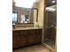 Bathroom featuring a vanity, mirror, and glass-enclosed shower at 12521 Floridays Resort Dr # 206F, Orlando, FL 32821