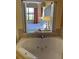 Spa-like bathroom featuring a soaking tub and a window view of the bedroom at 12521 Floridays Resort Dr # 206F, Orlando, FL 32821