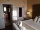 Comfortable bedroom featuring a king-size bed, bedside table with lamp, and bathroom access at 12521 Floridays Resort Dr # 206F, Orlando, FL 32821