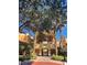 Attractive building exterior with Mediterranean-style architecture, landscaping, and gated entrance at 12521 Floridays Resort Dr # 206F, Orlando, FL 32821