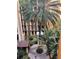 A garden courtyard in a resort community features tropical landscaping and relaxing walkway at 12521 Floridays Resort Dr # 206F, Orlando, FL 32821