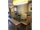 The dining area boasts a glass top table with modern chairs, bench seating and a contemporary light fixture at 12521 Floridays Resort Dr # 206F, Orlando, FL 32821