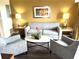 Living room with neutral walls, modern furniture, decor, window, lamps, and luxury vinyl plank flooring at 12521 Floridays Resort Dr # 206F, Orlando, FL 32821