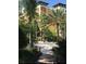 Sand playground area surrounded by tropical trees and greenery near the apartments at 12521 Floridays Resort Dr # 206F, Orlando, FL 32821
