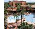 An aerial view of a beautiful pool and jacuzzi surrounded by lush tropical trees at a resort community at 12521 Floridays Resort Dr # 206F, Orlando, FL 32821