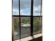View from a window overlooking a community pool, lake, and surrounding buildings at 12521 Floridays Resort Dr # 206F, Orlando, FL 32821