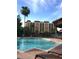 Refreshing pool with poolside lounge chairs at a stylish apartment complex under a sunny sky at 12521 Floridays Resort Dr # 206F, Orlando, FL 32821