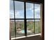 Scenic view of the pool, surrounding buildings, and lush greenery from a window at 12521 Floridays Resort Dr # 206F, Orlando, FL 32821