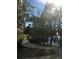 Scenic paved walkway along the lake, bordered by green landscaping and shady trees at 12521 Floridays Resort Dr # 206F, Orlando, FL 32821