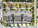 An aerial view of townhomes showcasing modern rooftops, private patios, and manicured landscaping at 13730 Bravante Aly, Windermere, FL 34786