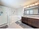 Bright bathroom featuring granite countertop, double sink vanity, shower, and tub at 13730 Bravante Aly, Windermere, FL 34786