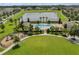 Aerial shot of a community pool, playground, lake and green spaces in a residential area at 13730 Bravante Aly, Windermere, FL 34786