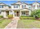 Attractive two-story townhouse with inviting front porch, brick walkway and manicured lawn at 13730 Bravante Aly, Windermere, FL 34786