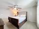 Main bedroom with a comfy bed, neutral walls, and ceiling fan, creating a relaxing space at 13730 Bravante Aly, Windermere, FL 34786