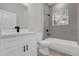 Clean bathroom with a vanity and shower-tub combo, highlighted by gray tile and black accents at 13817 Sw 43Rd Cir, Ocala, FL 34473