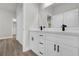 Bathroom vanity with double sinks, white cabinetry, quartz countertop and modern black fixtures at 13817 Sw 43Rd Cir, Ocala, FL 34473