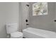 Bright bathroom features a shower-tub combo with gray tile and black hardware at 13817 Sw 43Rd Cir, Ocala, FL 34473