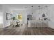 Well-lit dining area adjacent to a modern kitchen with stainless steel appliances and a breakfast bar at 13817 Sw 43Rd Cir, Ocala, FL 34473