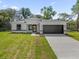 Charming single-story home featuring a two-car garage and well-manicured lawn at 13817 Sw 43Rd Cir, Ocala, FL 34473