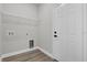 Utility room with new wood-look floor, wire shelf, and hookups for washer and dryer at 13817 Sw 43Rd Cir, Ocala, FL 34473