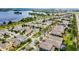 Beautiful aerial view of a lakeside neighborhood featuring well-maintained homes, and landscaped streets with mature trees at 15506 Tidal Cove Aly, Winter Garden, FL 34787