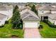 Aerial view of a charming single-Gathering home with a well-maintained lawn and brick driveway in a residential neighborhood at 15506 Tidal Cove Aly, Winter Garden, FL 34787