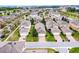 Aerial view of a residential neighborhood, showcasing well-manicured lawns and brick driveways by a calm lake at 15506 Tidal Cove Aly, Winter Garden, FL 34787