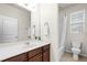 Bright bathroom features a vanity with a white countertop and a tub with shower at 15506 Tidal Cove Aly, Winter Garden, FL 34787