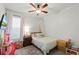 Charming bedroom with carpet floors, a ceiling fan and a large window at 15506 Tidal Cove Aly, Winter Garden, FL 34787