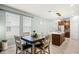 Dining area with a dark wood table and a view of the spacious open concept kitchen at 15506 Tidal Cove Aly, Winter Garden, FL 34787