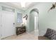 Inviting home foyer with neutral color palette, tile floors, and decorative fish art at 15506 Tidal Cove Aly, Winter Garden, FL 34787