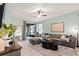 Inviting living room with a modern gray sofa and plenty of natural light at 15506 Tidal Cove Aly, Winter Garden, FL 34787