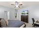 Main bedroom with a TV, an office area, and a doorway leading to the bathroom at 15506 Tidal Cove Aly, Winter Garden, FL 34787