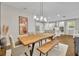 Spacious dining room with stylish lighting and a view into the modern kitchen at 16259 Misty Hills Ave, Winter Garden, FL 34787