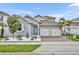 Charming two-story home with a two-car garage, blue door, and a well-manicured yard at 16259 Misty Hills Ave, Winter Garden, FL 34787