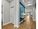 Inviting home hallway with wood floors, modern décor, and blue accent wall at 16259 Misty Hills Ave, Winter Garden, FL 34787