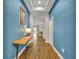 Inviting home hallway with wood floors, modern décor, and blue accent wall at 16259 Misty Hills Ave, Winter Garden, FL 34787