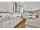 Well-lit kitchen with white cabinets, granite countertops, and stainless steel appliances at 16259 Misty Hills Ave, Winter Garden, FL 34787